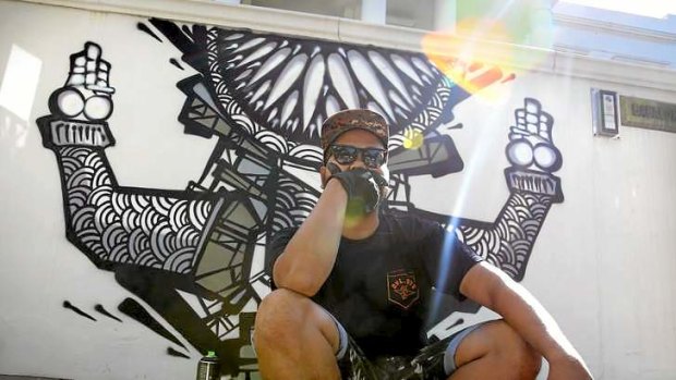 Trademark: Indonesian street artist Darbotz with some of his work in Toorak.