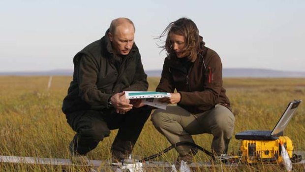 Field trip ... Vladimir Putin listens to a member of the scientific expedition in the Russian Arctic.