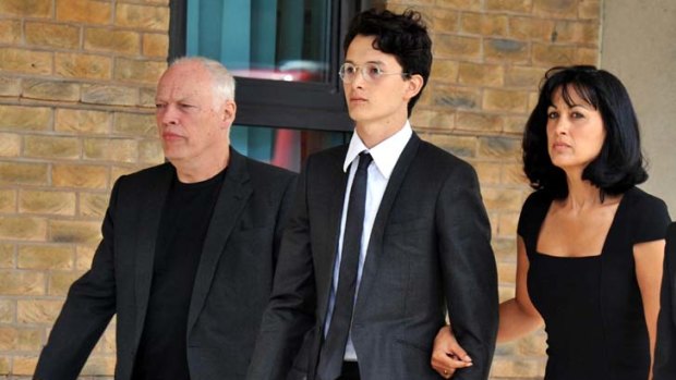 Sentenced to 16 months behind bars ... Charlie Gilmour, 21, walks with his father, Pink Floyd guitarist David Gilmour, and his mother, Polly Samson.