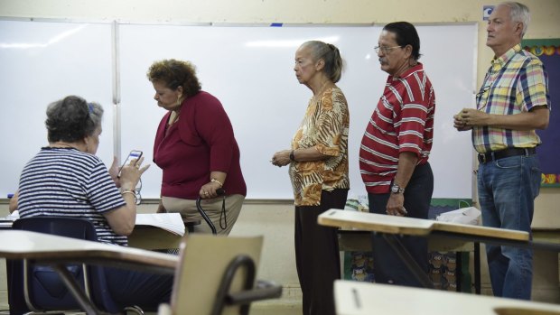 Residents line up to vote during a US election.