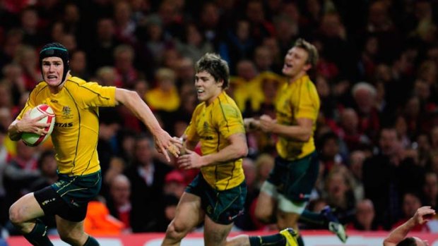 Running hot: Berrick Barnes sprints for the line to score the Wallabies' third try in Cardiff.