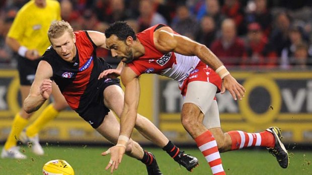 Dustin Fletcher and Adam Goodes compete for the ball.
