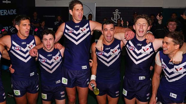 Fremantle players celebrate their win over Sydney.