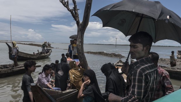 Disembarking from a boat after crossing the bay to Shah Porir Dwip, Bangladesh.