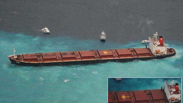 The Chinese-registered bulk coal carrier Shen Neng 1 aground 70 kilometres east of Great Keppel Island. INSET: A close-up of the ship shows oil leaking from it's port side.