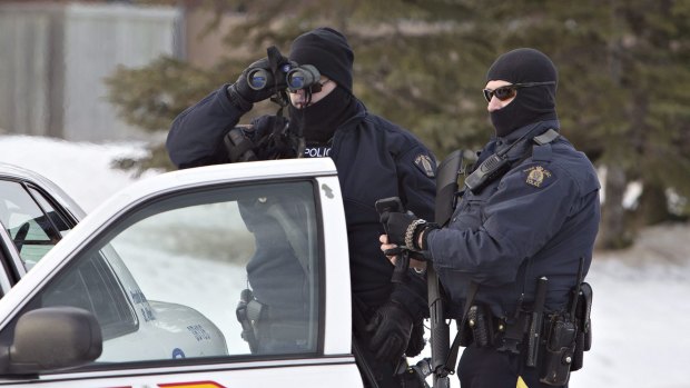 Police search for a suspect in the shooting of two Mountie police officers in St. Albert, Alberta, Canada, on Saturday, January 17, 2015.