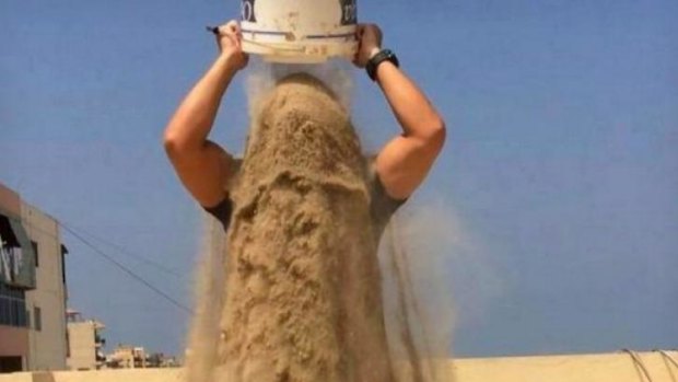 A man raises awareness of the Gaza conflict by taking the 'rubble bucket challenge'.