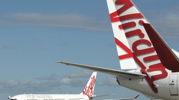 A Virgin flight has been forced to turn back when liquid from the bathrooms was found in the aisle.