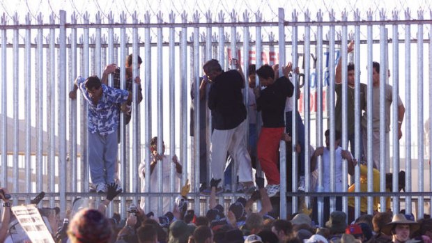 Detainees  breaking out of the Woomera detention centre during a protest where demonstrators broke though the outer perimiter fence of the centre and went up to the main fence.