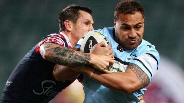 Forward thinking: Sharks prop Sam Tagataese is tough for Roosters halfback Mitchell Pearce to bring down.