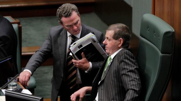 Hot seat: Manager of opposition business Christopher Pyne talks with the newly installed Speaker Peter Slipper during question time yesterday.