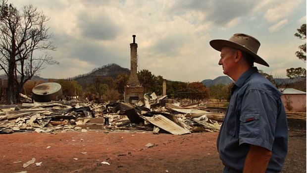 ''Nothing that man makes lasts forever'' ... Vincent Morrissey surveys the damage in front of what used to be his home in Morrisseys Lane, Coonabarabran. The fire front now extends for 158 kilometres.