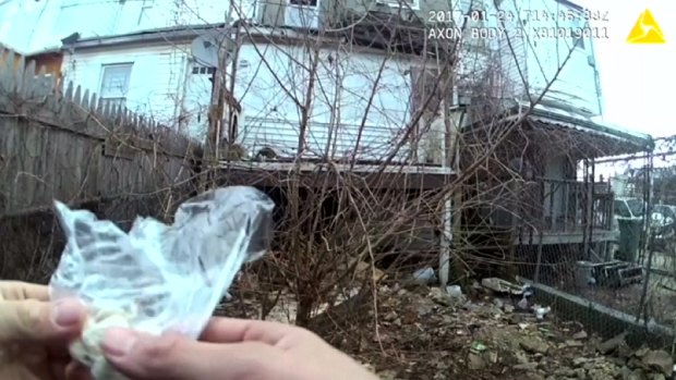 Another video released last last month by Baltimore's public defender appeared to show an officer planting a small bag of capsules in a trash-strewn yard.