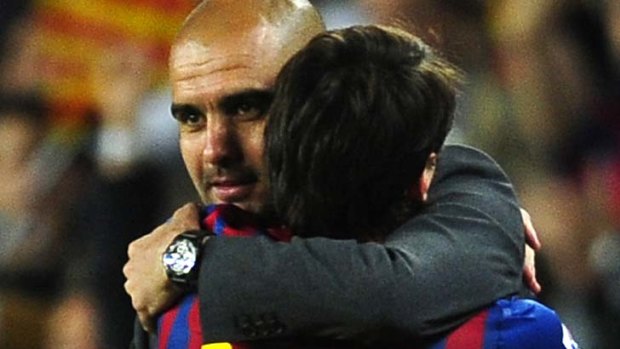 Barcelona coach Pep Guardiola embraces Lionel Messi.