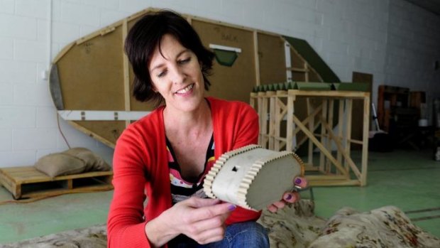 Artist Samantha Small holding the original model of her work Stalemate in her Fyshwick studio.