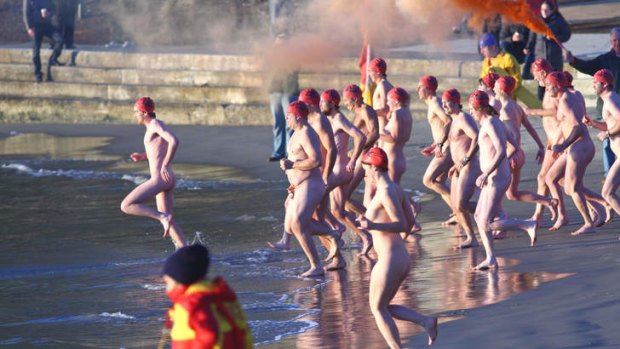 Skinny dipping: Hardy souls brave the Derwent River in Hobart's nude winter solstice swim.