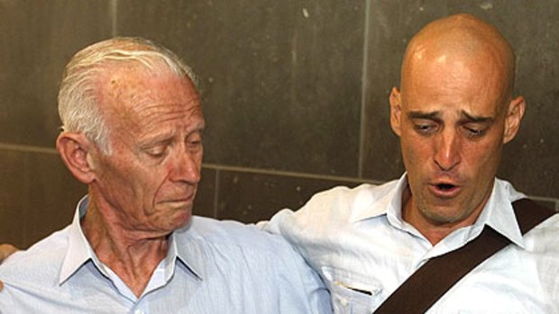 Harry Nicolaides (right) cries as he is embraced by his father Socrates at Melbourne Airport.