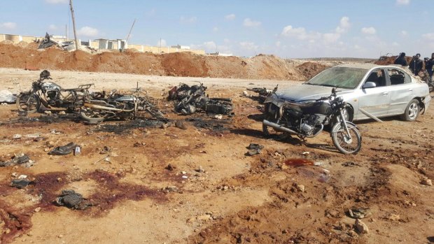 This image released by the Thiqa News Agency shows damaged motorcycles and a car following a suicide blast in Sousian village, about eight kilometres north of al-Bab, Syria on Friday.