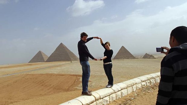 A rare sight ... two tourists at the Giza pyramids on the outskirts of Cairo this week.