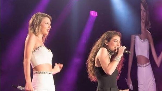 Lorde and Taylor Swift on stage.