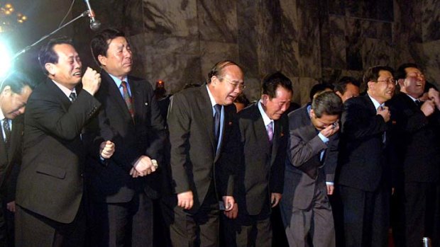 Senior officials weep as they visit the Kumsusan Memorial Palace in Pyongyang where Kim Jong-il's body is lying in state.
