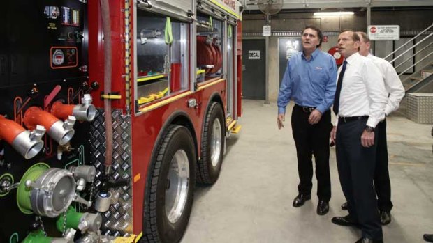 Tony Abbott admires a fire engine.