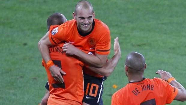 Centre of attention ... Wesley Sneijder celebrates with teammates John Heitinga and Nigel de Jong after scoring against Slovakia.