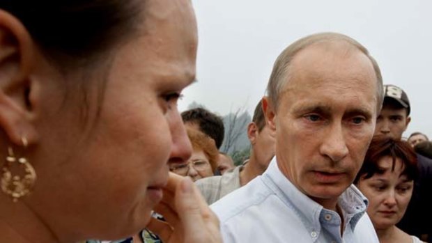 Russian Prime Minister Vladimir Putin speaks with local residents who lost their homes to fire near Nizhny Novgorod.