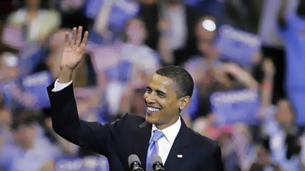 Barack Obama waves to supporters at his victory rally in St Paul.