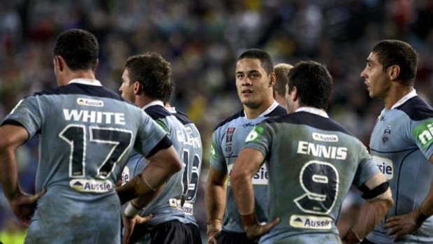 The agony and the ecstasy ... NSW players gather after conceding a try to Queensland in Origin I on Wednesday night.
