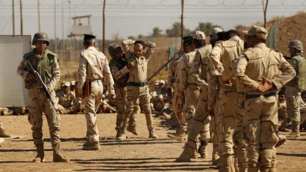 Iraq army recruits during a training session in how to search people at Camp Taji.