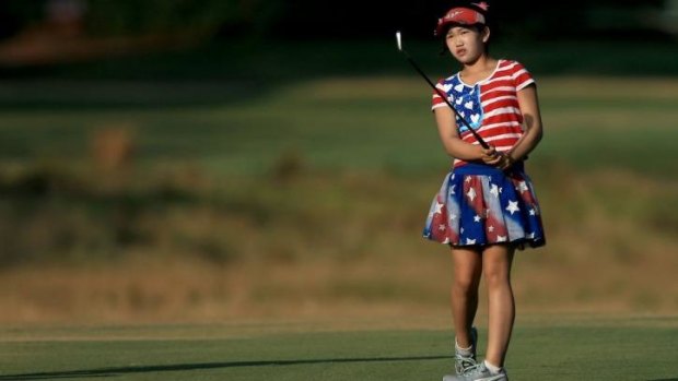 Eleven-year-old Lucy Li watches her shot on the 12th hole during the first round of US Women's Open.