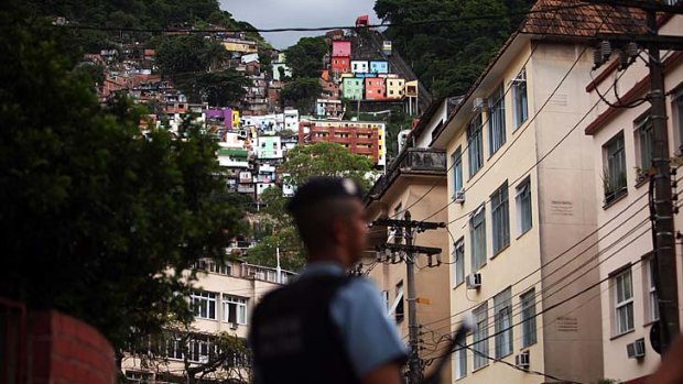 Guardian &#8230; a police officer stands on the edge of the ''pacified'' Santa Marta favela. There has not been a murder there in four years.