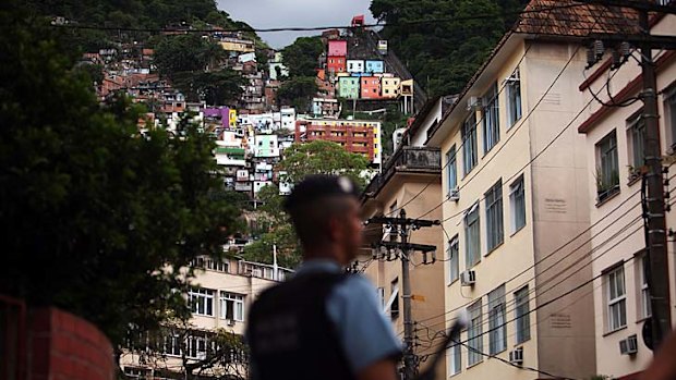 Guardian &#8230; a police officer stands on the edge of the ''pacified'' Santa Marta favela. There has not been a murder there in four years.