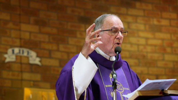 Parish priest Father Michael Shadbolt delivers a sermon at the Holy Family church in Doveton on Sunday. 