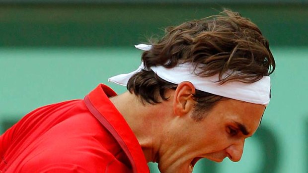 Roger Federer celebrates a point during the semi-final against Novak Djokovic.