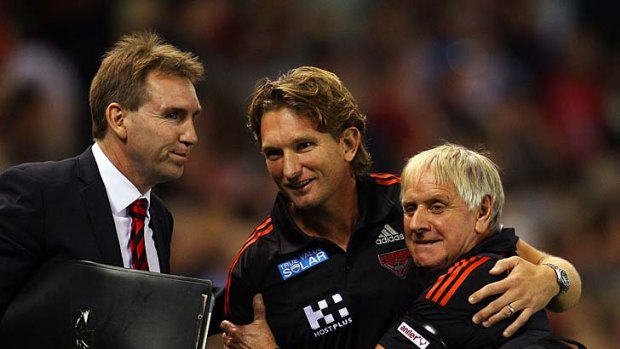 James Hird and his staff relax after the two-point win.