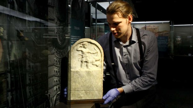 RD Milns Antiquities Museum Senior Museum Officer James Donaldson holds a memorial tablet for young girl named Vitalinis who died at 8 years of age around AD 50-150.