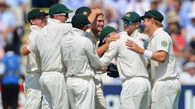 Ryan Harris celebrates the wicket of Kevin Pietersen with teammates.