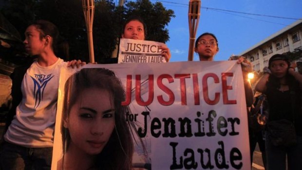 Demonstrators display a banner while holding torches, seeking justice for murdered Filipino transgender Jeffrey Laude, who also goes by the name Jennifer, during a protest along a main street of Manila on the weekend. 