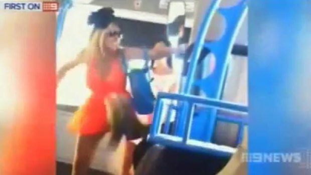 Two girls are caught on film attacking a half-blind man on a Gold Coast bus.