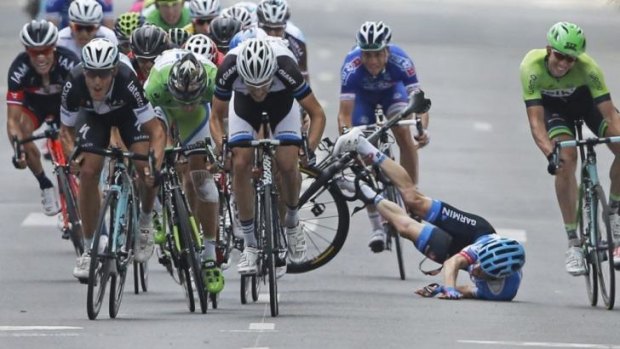Andrew Talansky of the US crashes as the pack with stage winner Italy's Matteo Trentin, foreground left, sprints towards the finish line during the seventh stage in Nancy, France.