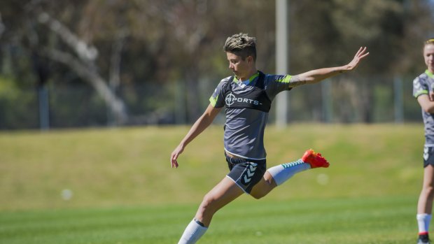 Canberra United striker Michelle Heyman launches into a shot at training on Saturday.