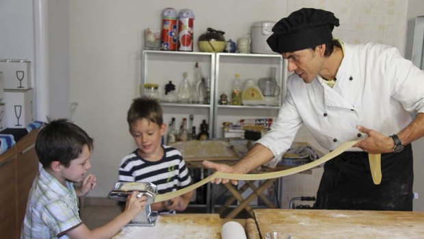 Junior foodies: Fabrizio teaches Kate Farrelly's sons, Patrick and Braden, how to make spaghetti.