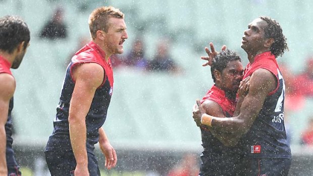 Demons together: Aussie Wonaeamirri (left) and Liam Jurrah celebrate a Melbourne goal yesterday.