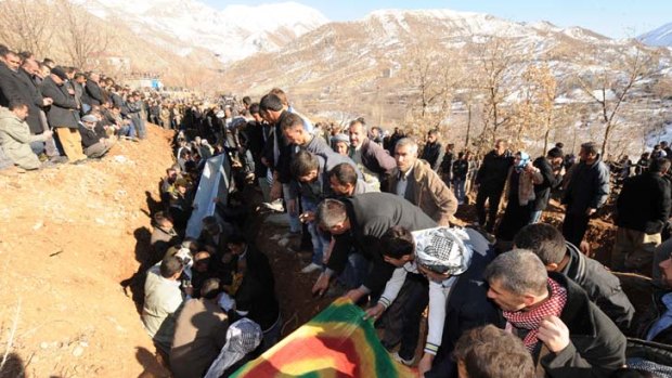 In mourning ... villagers bury some of the victims of the air strike.