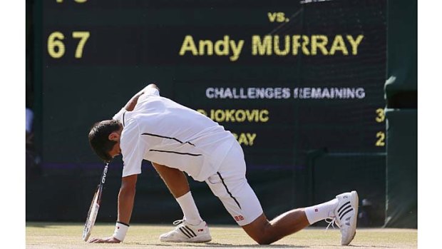 Fallen hero... Novak Djokovic slips during a point.