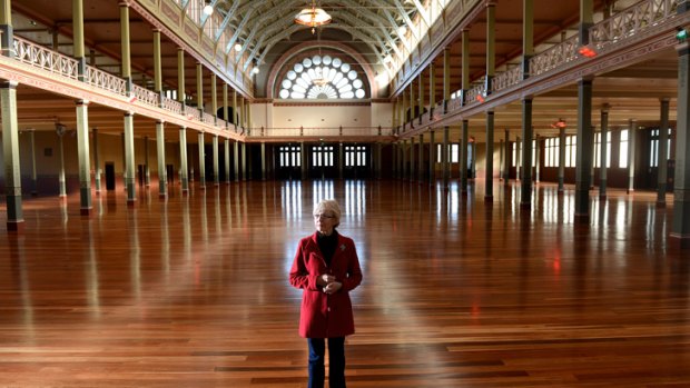 Greta Bird from the Carlton Residents Association inspects the Royal Exhibition Building, which will receive $20 million in funding.