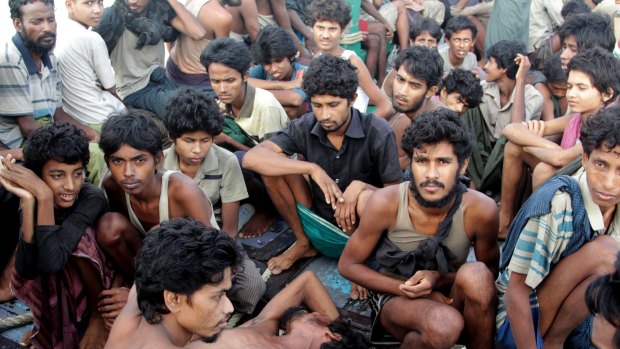 Migrants sit on the deck of their boat as they wait to be rescued by Acehnese fishermen.