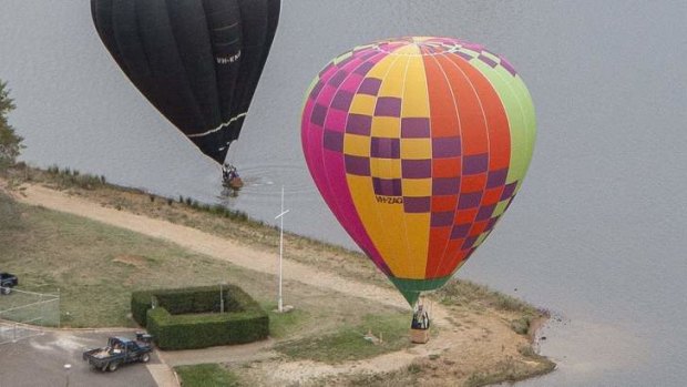 A balloon lands in Lake Burley Griffin this morning.